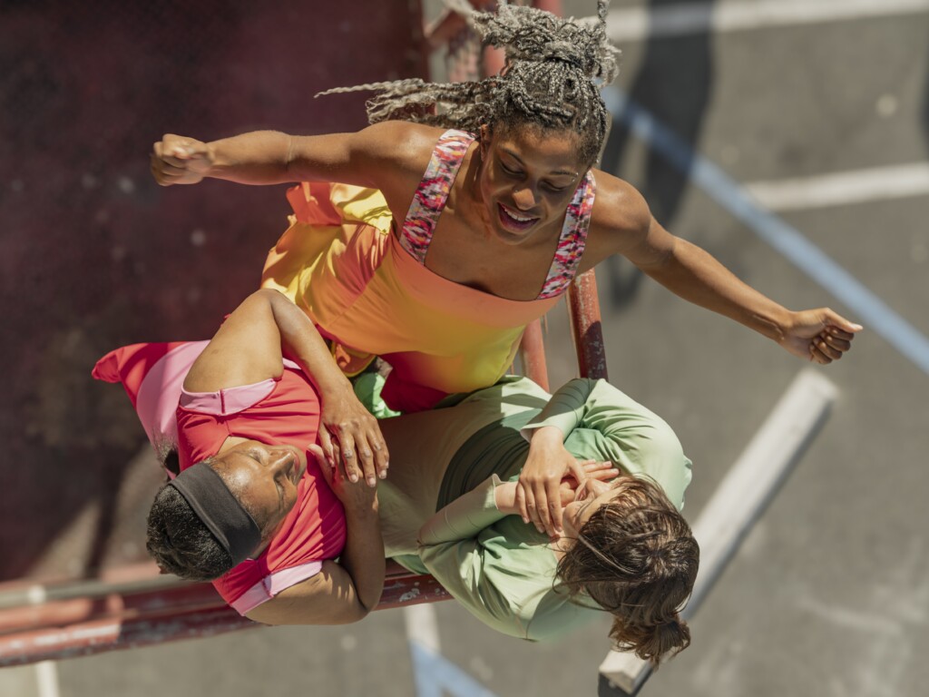 Dancers Laura Elaine Ellis, Jhia Jackson, and Ai Yin Adelski circling around each other on a fire escape.