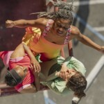 Dancers Laura Elaine Ellis, Jhia Jackson, and Ai Yin Adelski circling around each other on a fire escape.