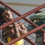 Jhia Jackson and Ai Yin Adelski dancing on a fire escape.