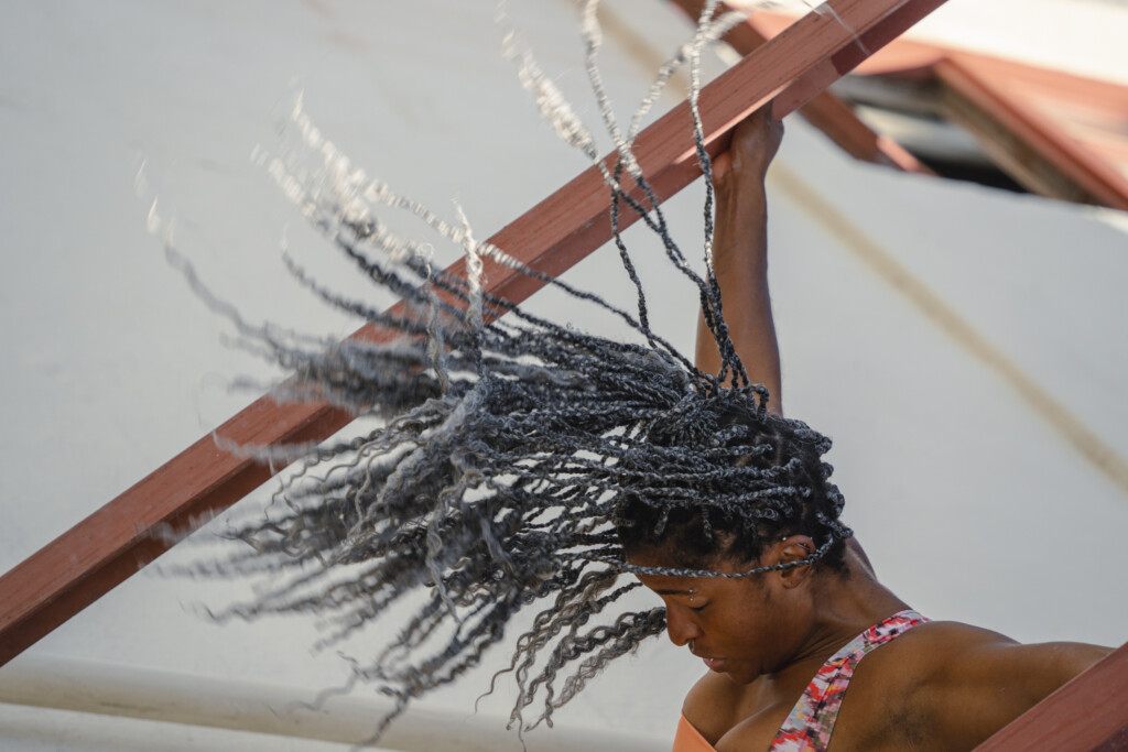 Jhia Jackson dancing on a fire escape.