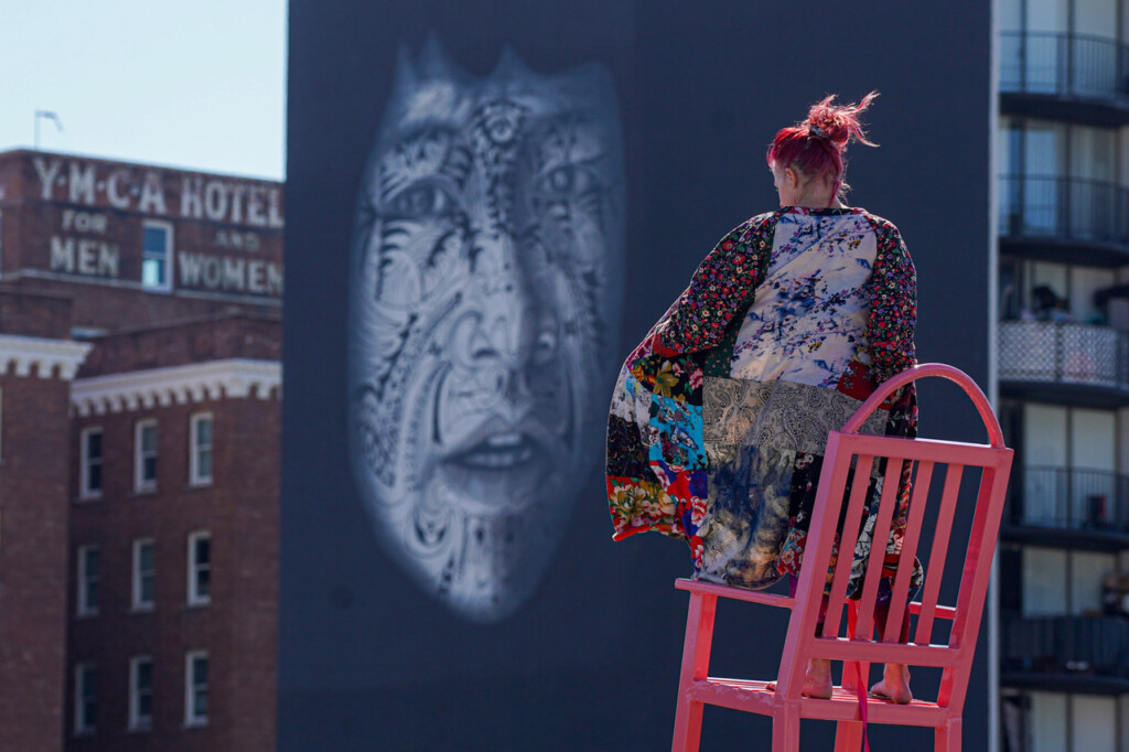 Sonsherée Giles dancing on a pink rocking chair above the Tenderloin.