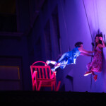 Megan Lowe and Saharla Vetsch dancing on the side of the Cadillac Hotel