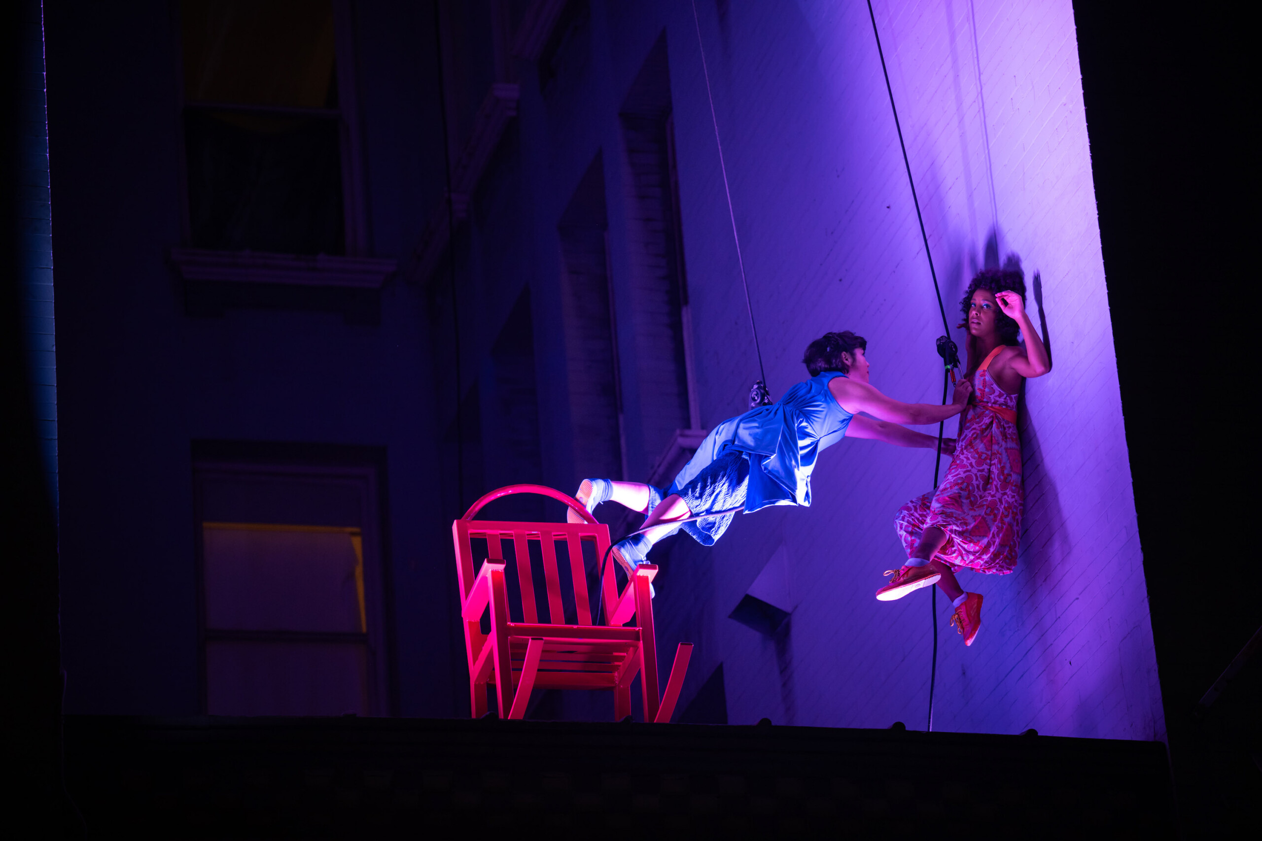 Megan Lowe and Saharla Vetsch dancing on the side of the Cadillac Hotel