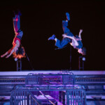 Megan Lowe and B Dean dancing on a fire escape suspended by rope and harness