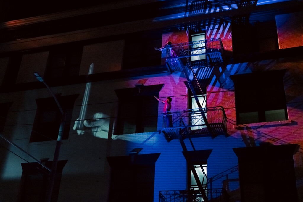 Quinn Dior and Gabriele Christian dancing on a fire escape.