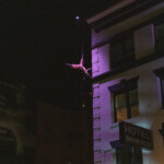 MaryStarr Hope dancing on a the side of a building suspended by rope and harness